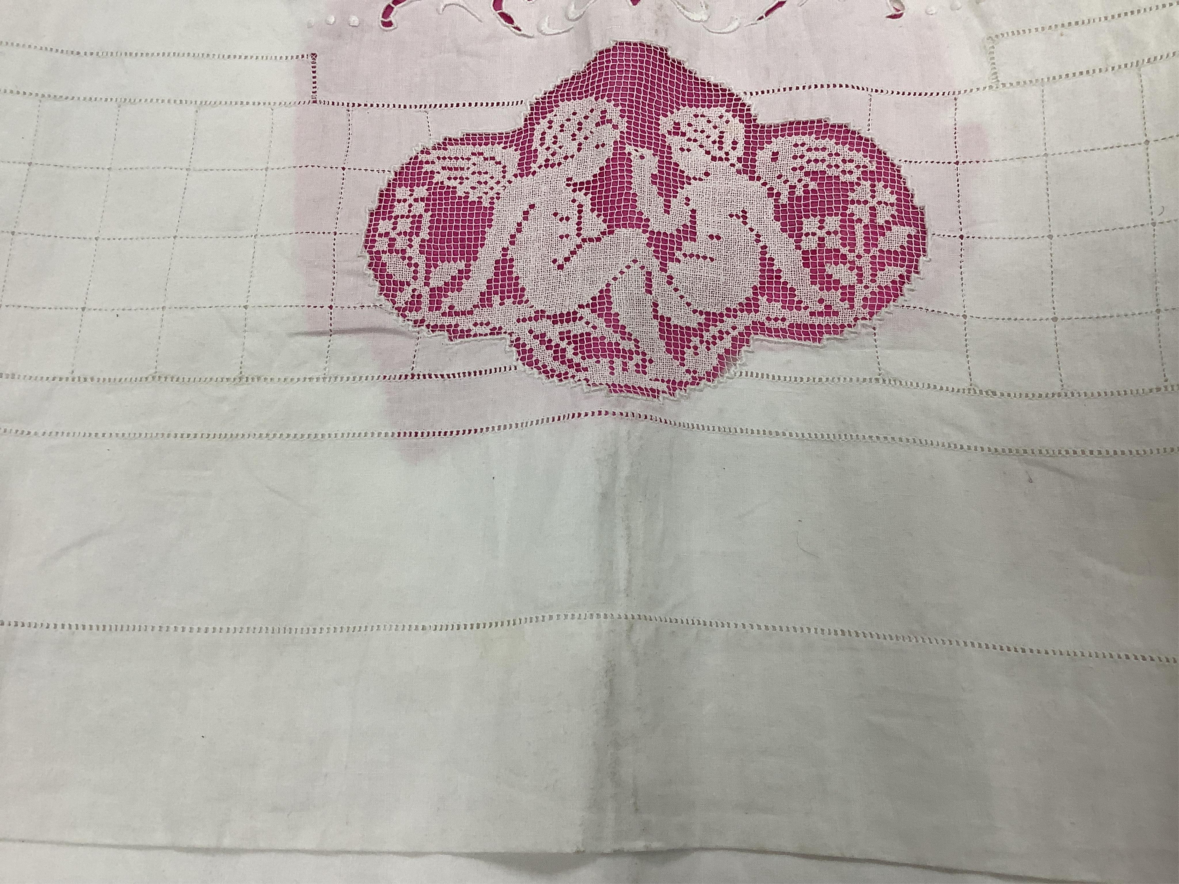A late 19th / early 20th century continental fine linen top sheet and near matching square pillowcase. The sheet designed with an ornate turn back with a fillet putti inset, fillet bird insets, a cut work embroidery cart